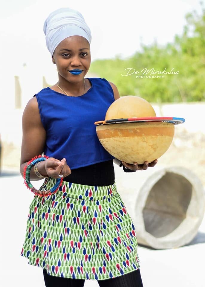 Woman holding a calabash in traditional dress