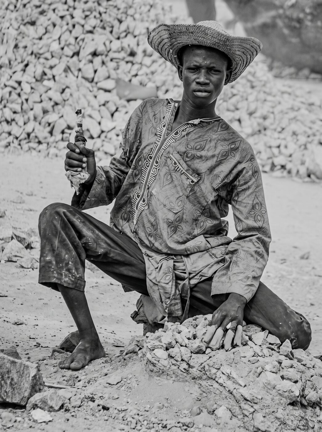 Black and white portrait of a man in a straw hat