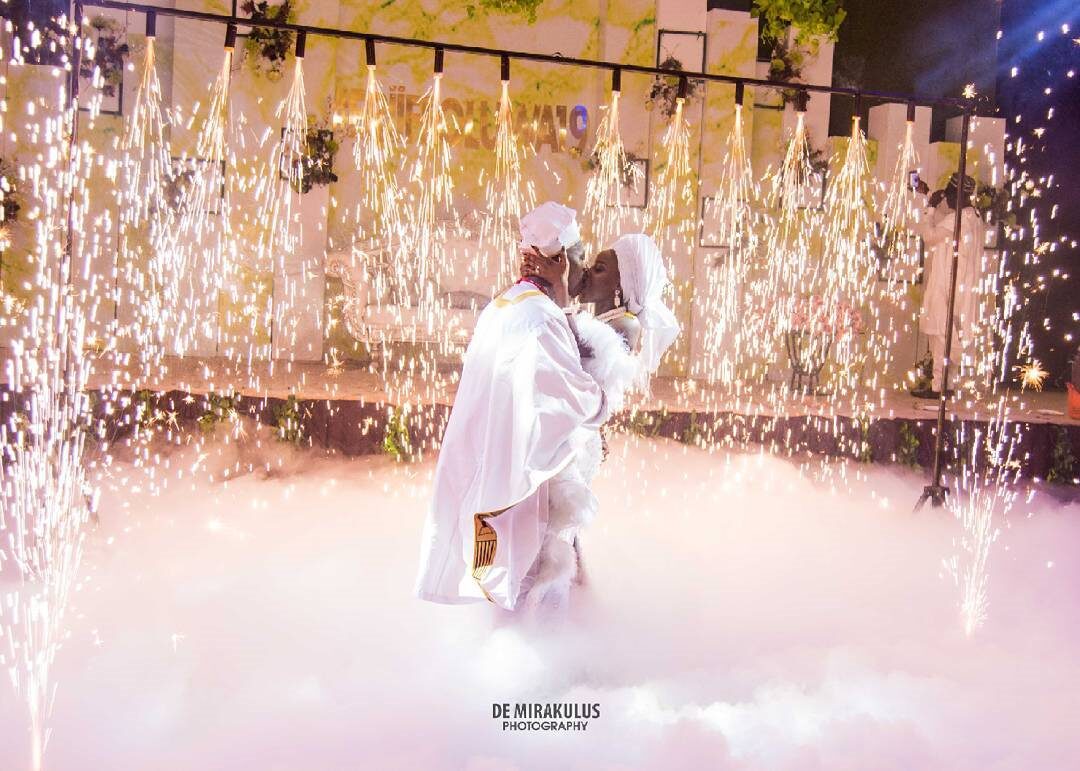 Bride and groom first dance among cold sparks