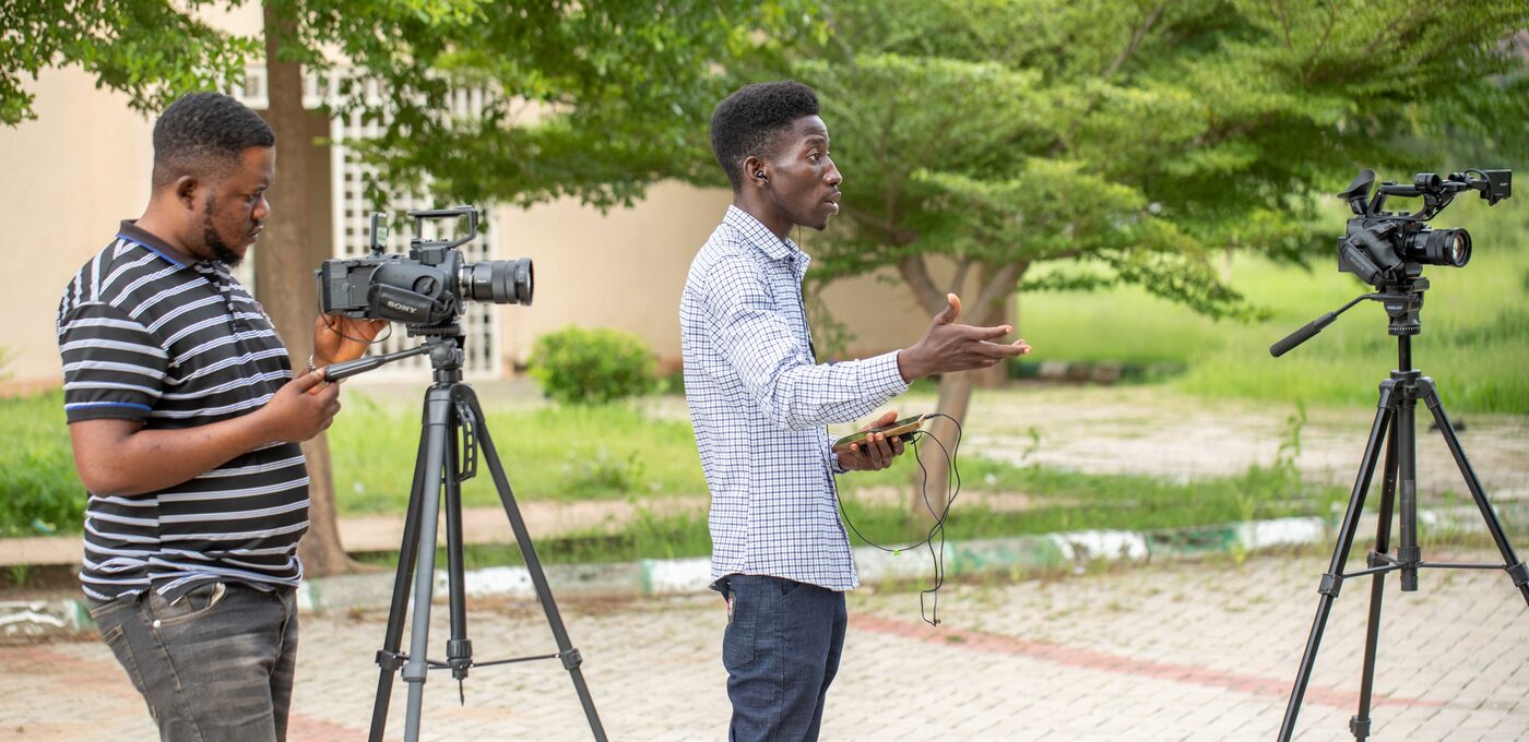 Documentary crew interviewing a subject outdoors